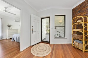 Relax in this serene space with a view of lush greenery from the outdoor area.