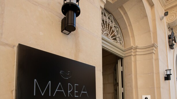 A sign for Marea Boutique Hotels with a modern design, an entrance door, and a decorative metal railing. - Marea Boutique Hotels (Sliema)
