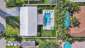 Vue aérienne d’une propriété résidentielle dotée d’une piscine, d’un patio et d’un garage.