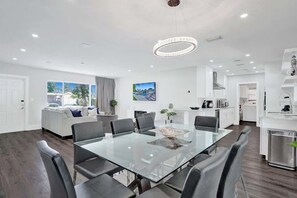 A modern interior with a dining area, kitchen, and living space.