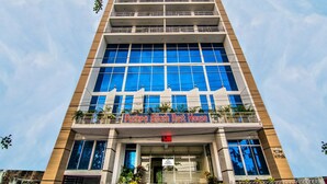 A tall building with a sign reading "Pushpo Bilash Rest House" at the entrance. - HOTEL PUSHPO BILASH (Khulna)