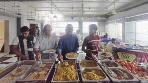 A buffet setup with various food items and people serving. - HOTEL PUSHPO BILASH (Khulna)