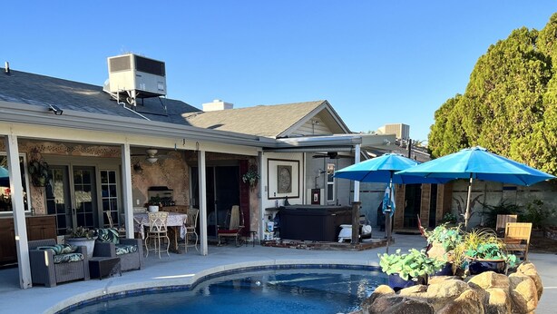 A backyard with a swimming pool, outdoor furniture, and a covered patio area. - Staycation Home minutes to all Pheonix has to offer (Glendale)