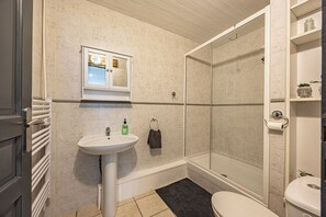 Bathtub, hair dryer, towels, soap