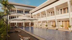 A multi-level hotel with a swimming pool, outdoor seating, and potted plants. - Molly Resort Bohol (Panglao)