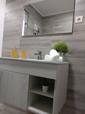 Shower, hair dryer, towels, toilet paper