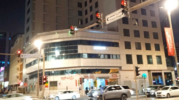 A multi-story building with a prominent entrance at the ground level. - Ali Jasem Group (Doha)