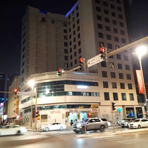 A multi-story building with a prominent entrance at the ground level. - Ali Jasem Group (Doha)
