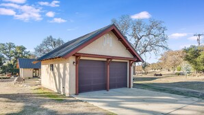 A single-story building with a garage, a sloped roof, and a small porch. - Harmony Over The Hill (Templeton)