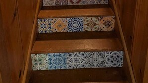 A wooden staircase with patterned tiles. - Trailview: Walk to Stadium! Free Fubo for World Cup, Plenty of Parking!  Dogs OK (Raytown)