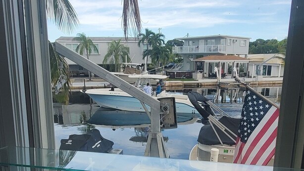 A model ship on a display shelf with a view of a marina and buildings in the background. - Key Largo heavenly retreat (Key Largo)