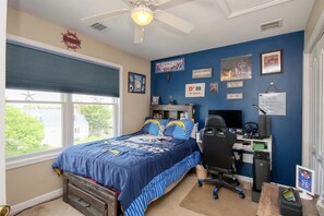 A bedroom with a bed, desk, chair, and a window with blinds. - Ultimate Summer Oasis and private resort like home! (SEASIDE HEIGHTS)