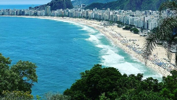 A coastal cityscape with a beach, mountains, and a dense urban area. - The Coral Penthouse - 3 Bedrooms (Rio de Janeiro)