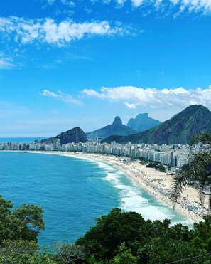 A coastal cityscape with a beach, mountains, and a dense urban area. - The Coral Penthouse - 3 Bedrooms (Rio de Janeiro)