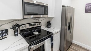 A compact kitchen with a microwave, oven, and refrigerator. - So Flo Getaway, * Close to beach! * (Fort Lauderdale)