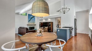 A modern kitchen with a central island, white cabinetry, and a built-in oven. - Your escape to Napa Valley (Yountville)