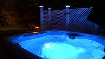 Private hot tub glowing at night