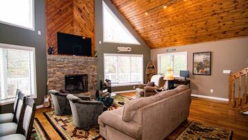 Smart TV, fireplace, books, computer monitors
