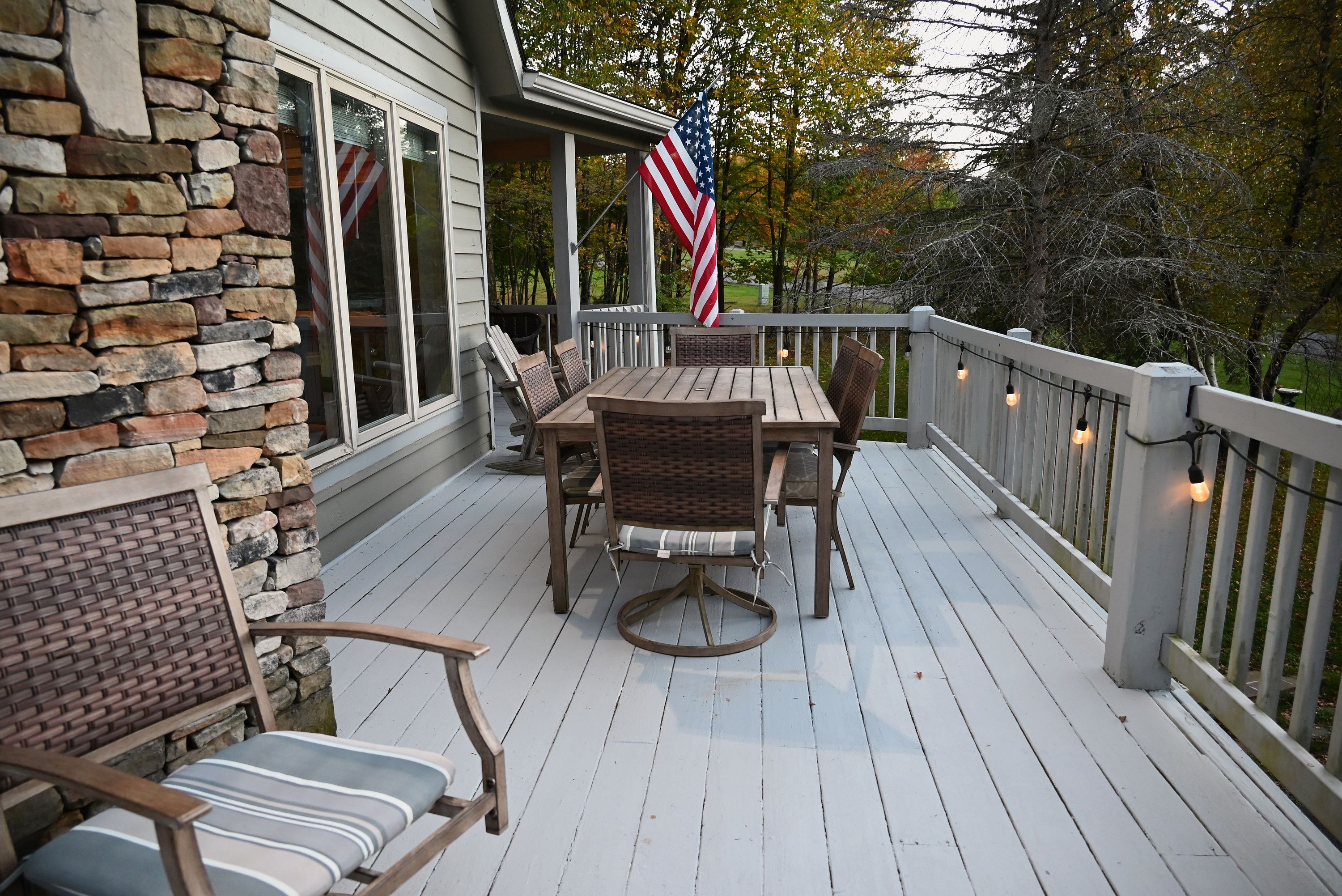 Deck with outdoor dining for six and string lights