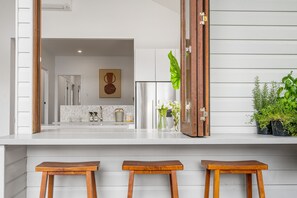 Enjoy dining and socializing in this inviting kitchen with a large mirror and comfortable seating.