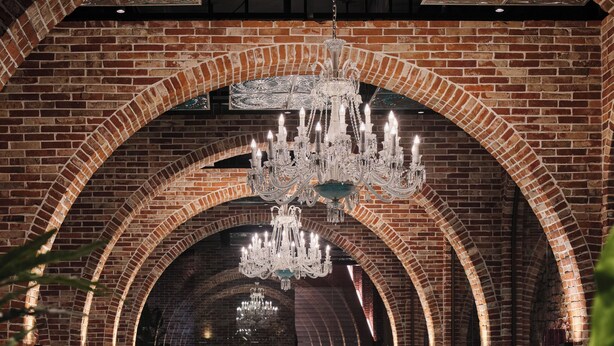 An indoor swimming pool with arched brick walls and a chandelier. - ANANTI AT GANGNAM (Seoul)