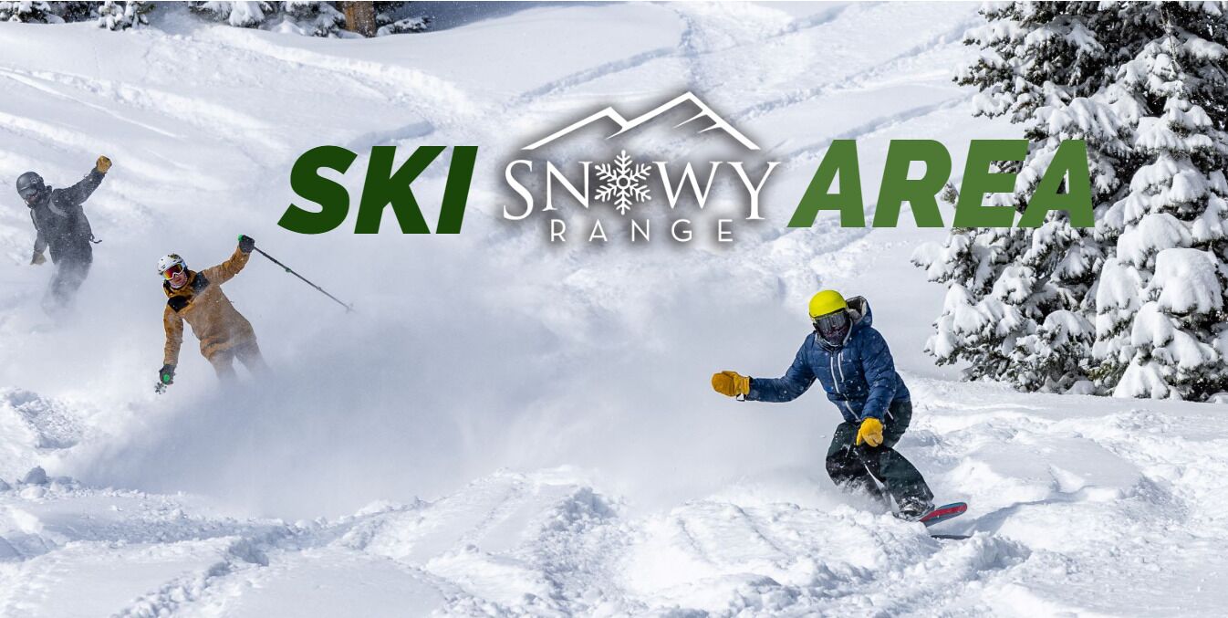 A ski slope with skiers in motion.