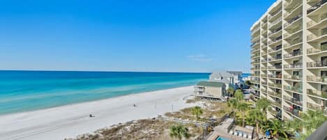 A beachfront hotel with a pool and beach access.