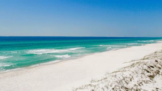A beach with white sand and clear blue water. - Absolute Beach ~ Pet-Friendly Townhome with Private Backyard (Panama City Beach)