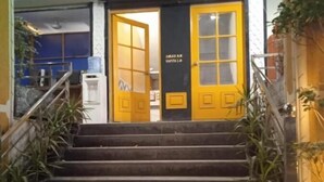 A staircase leading to a room with yellow doors and a sign that reads "Welcome". - Dastak Hotels  (Islamabad)