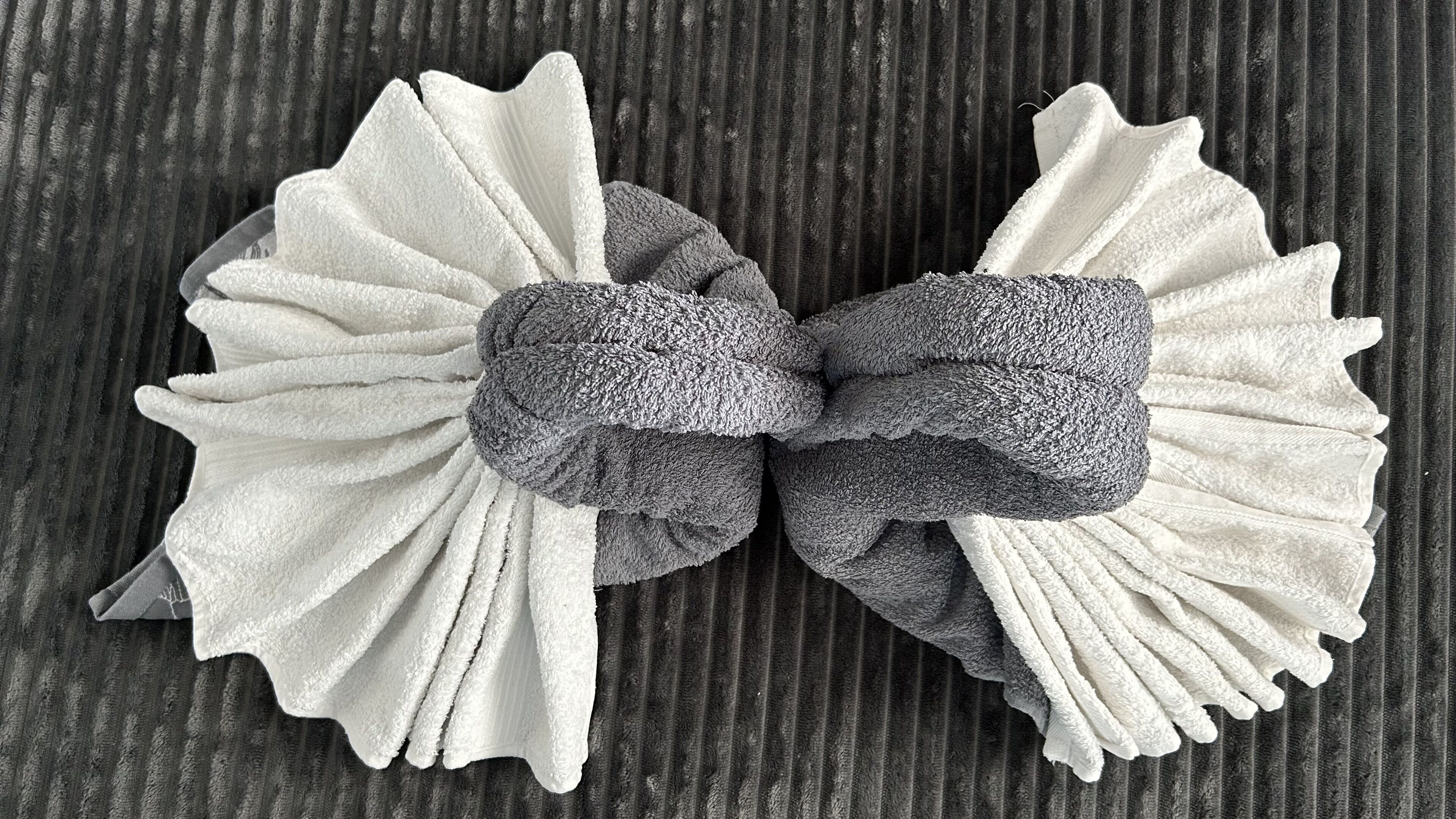 A bow tie made of two different textured fabrics, tied in the center.