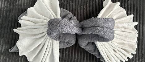 A bow tie made of two different textured fabrics, tied in the center.