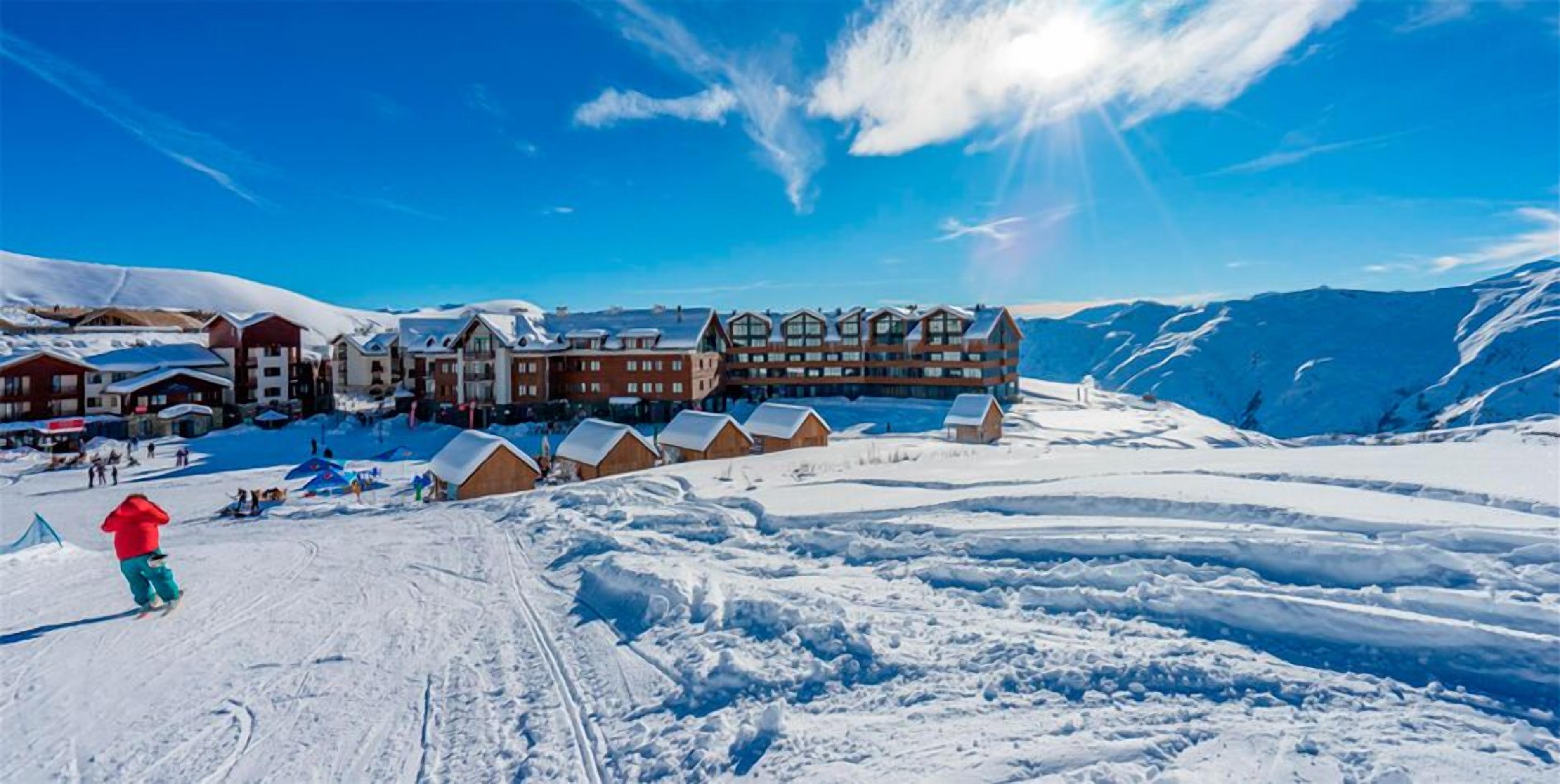 A ski resort with multiple lodges and a ski slope.