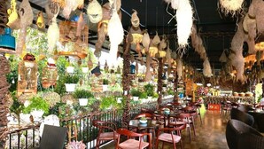 A restaurant with hanging decorations, tables, and chairs. - CALI PHU QUOC HOTEL (Phu Quoc)
