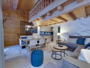 A modern interior with a dining area, kitchen, and living space.