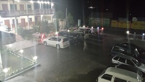 A parking lot with several cars and a white van. - Mezban Hotel & Restaurant (Balakot)