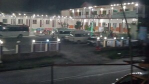 A multi-story building with balconies and a parking area. - Mezban Hotel & Restaurant (Balakot)