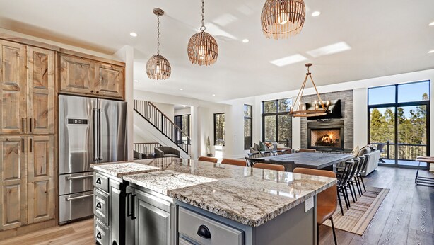 A modern kitchen with a large island, stainless steel appliances, and a fireplace. - Pet Friendly | Minutes to Lift | Hot Tub | Blue Mountain Escape (Angel Fire)