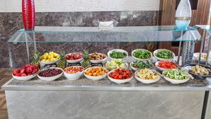 A buffet with various fruits and vegetables arranged on a marble countertop. - Dedeman Kemer Resort - Ultra All Inclusive (Kemer)