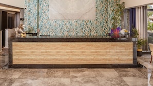 A modern lobby with a marble reception desk, patterned walls, and a large chandelier. - Dedeman Kemer Resort - Ultra All Inclusive (Kemer)