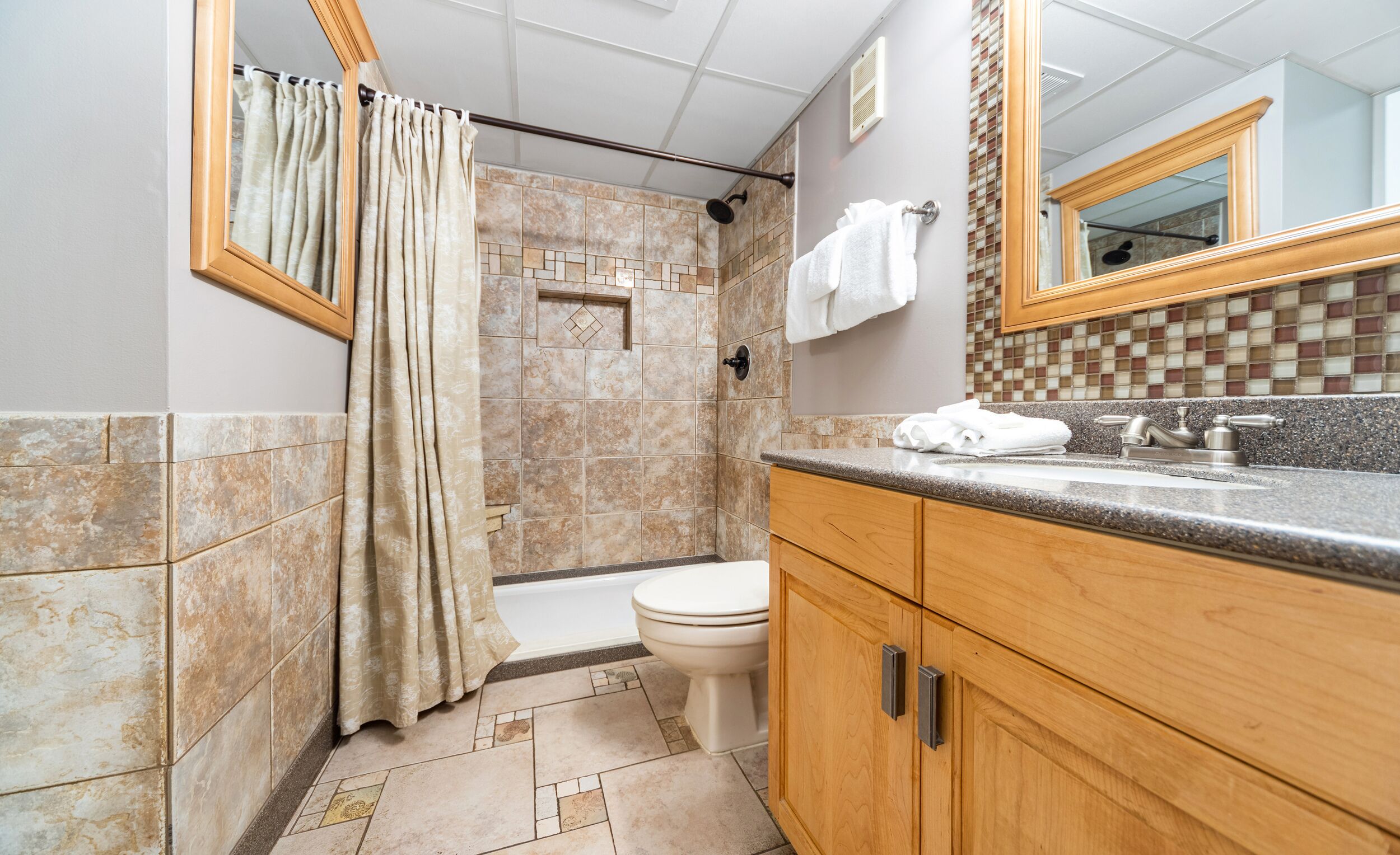 Un baño con ducha, inodoro y lavamanos.