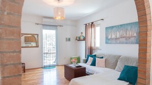 A bedroom with a bed, a desk, a chair, a window with curtains, and a painting on the wall. - Country Home Matkovic - Duba (Konavle)