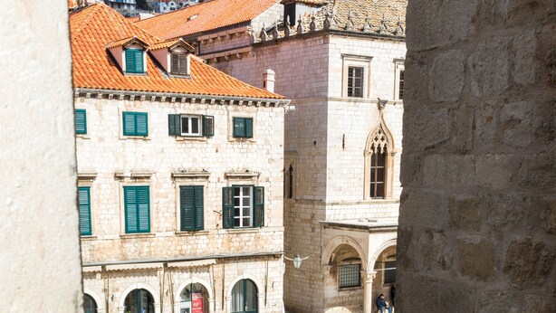 A view from a window with a glass of red wine and a book titled "Daniele Stil" on a table. - Apartment Toni (Dubrovnik)