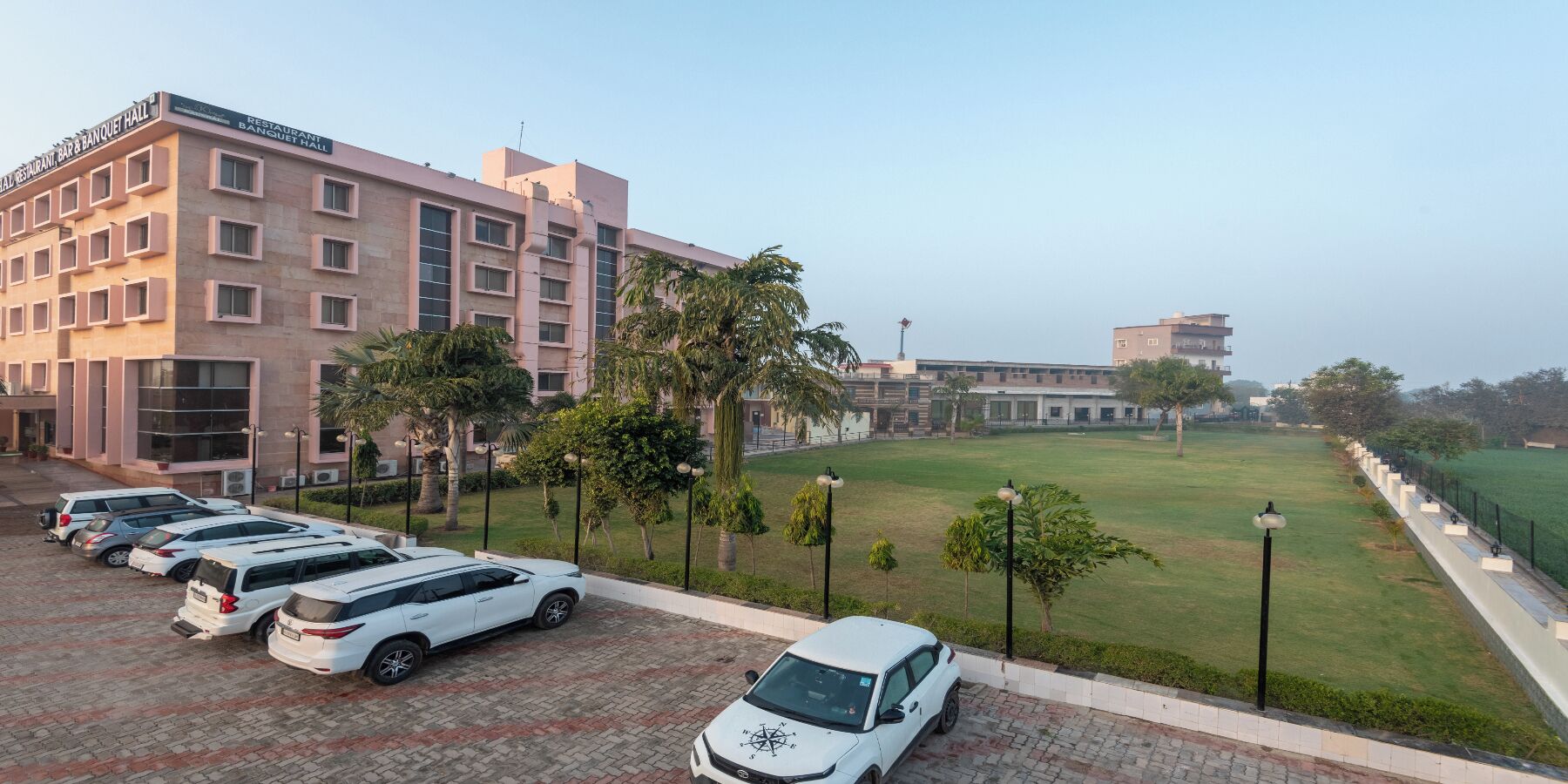 A hotel with a parking lot, a restaurant, and a banquet hall.