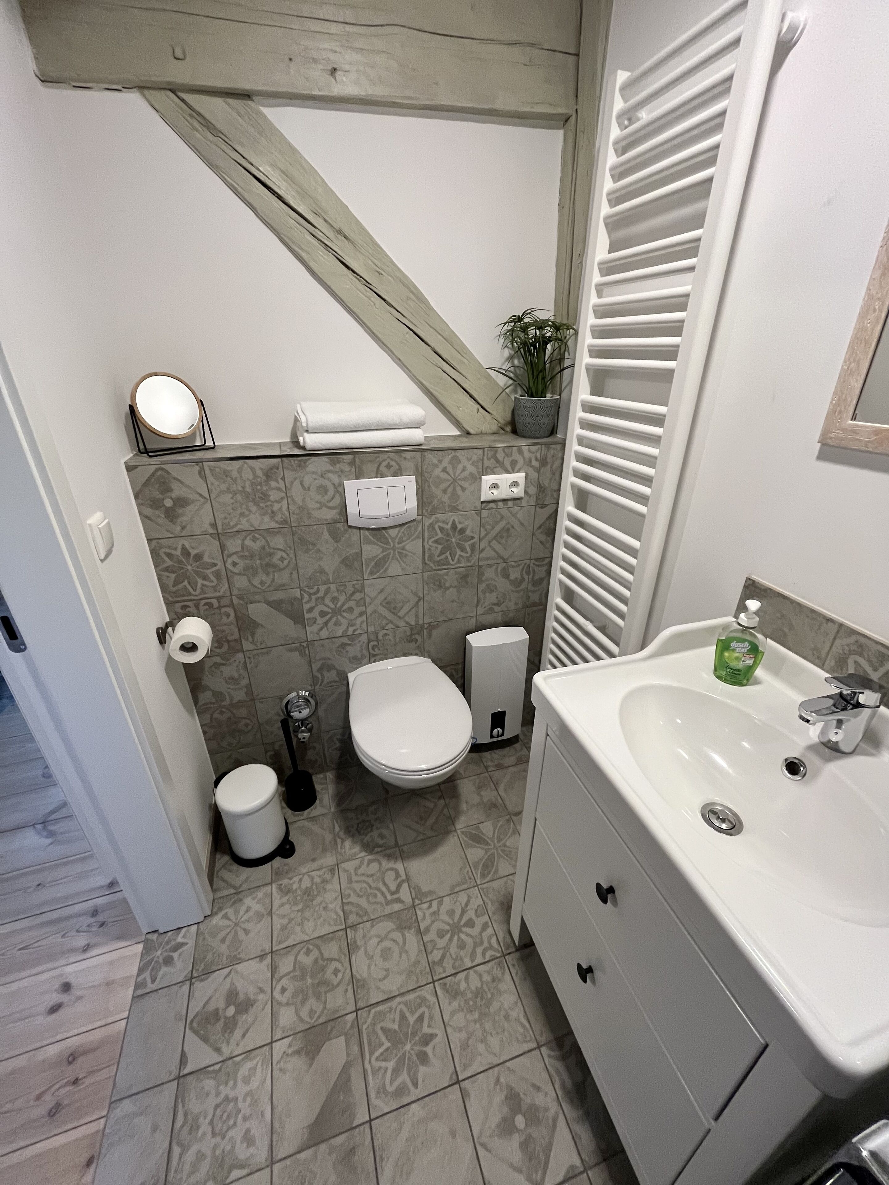 A bathroom with a toilet, sink, and shower.