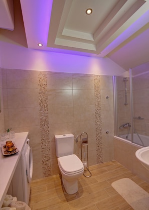 A modern bathroom with a toilet, bidet, and shower.