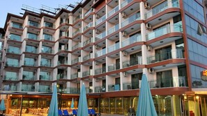 A multi-story hotel with a swimming pool, outdoor seating, and a modern architectural design. - UK Blue Coast Hotel  - Adults Only (Alanya)