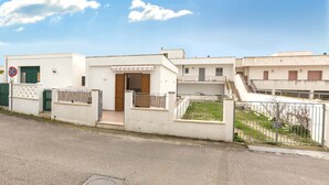 A residential building with a gated entrance, a small balcony, and a staircase leading to an upper level. - 2214 Villetta Enea - Mono 1 by Barbarhouse (Castro)