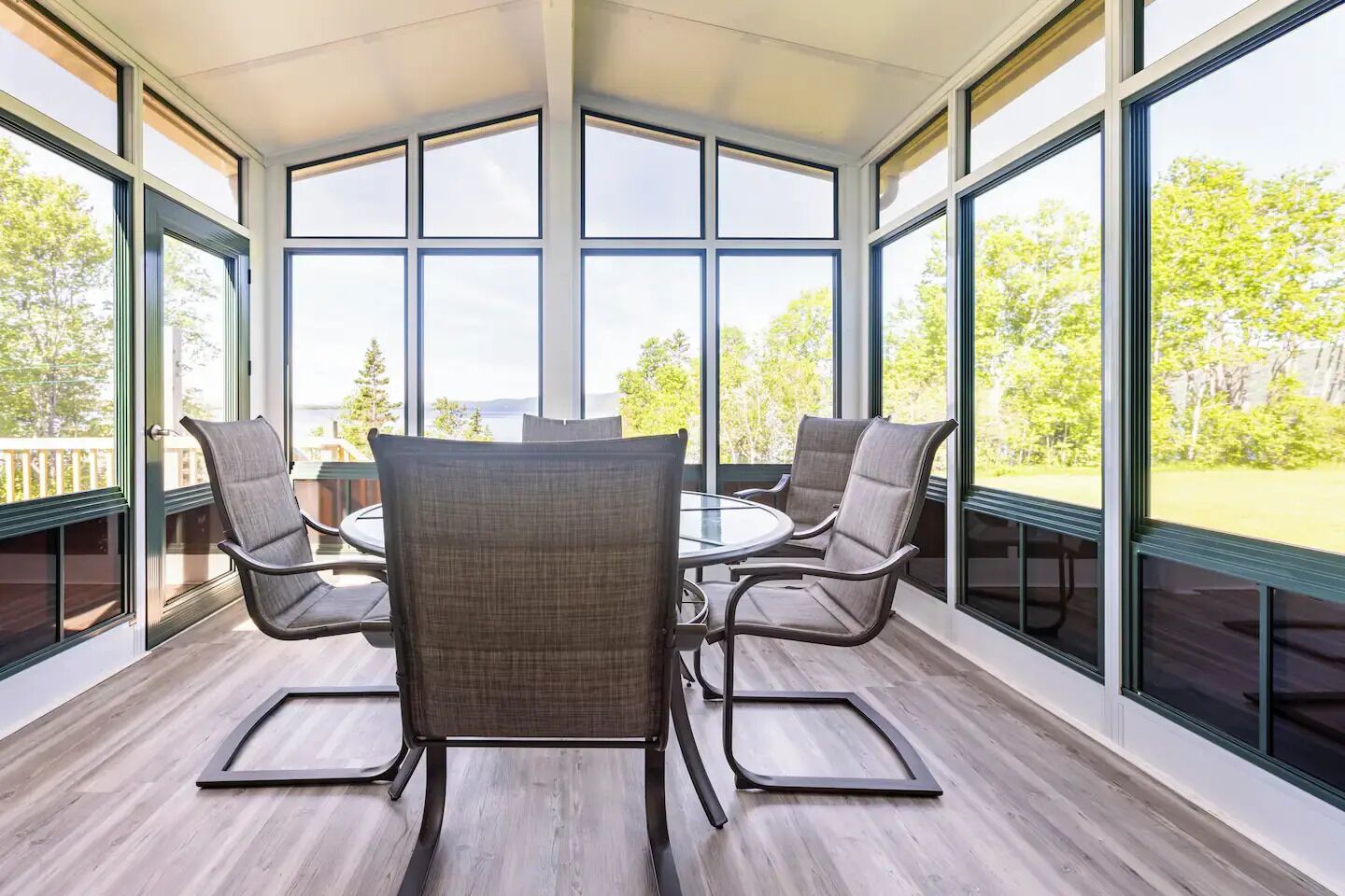 Fully screened sunroom where you can open the windows and enjoy the lake breeze