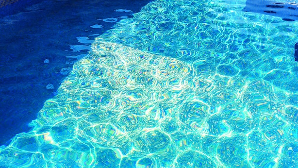 A clear view of a swimming pool with visible ripples and reflections on the water surface. - Villa Anka (Dubrovnik)