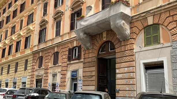 A multi-story building with a classical architectural style, featuring arched windows and decorative stonework. - Cavalieri Affittacamere (Rome)